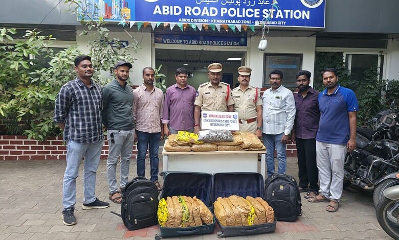 Police officers and suspects with seized dry ganja outside Abid Road Police Station in Hyderabad.