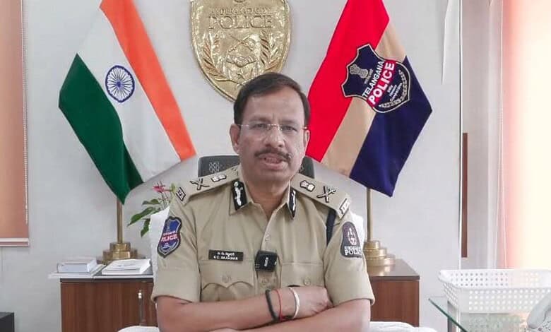 Hyderabad Police Commissioner VC Sajjanar in uniform with Indian and police flags behind him.