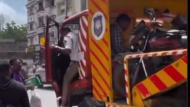 Police officials pushes a delivery agent away after seizeng vehicle in Hyderabad