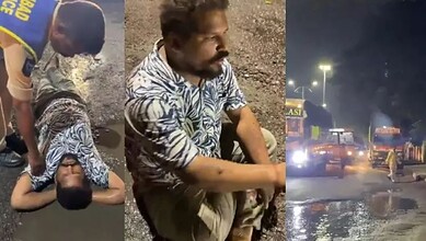 Man sits in a pothole in Hyderabad