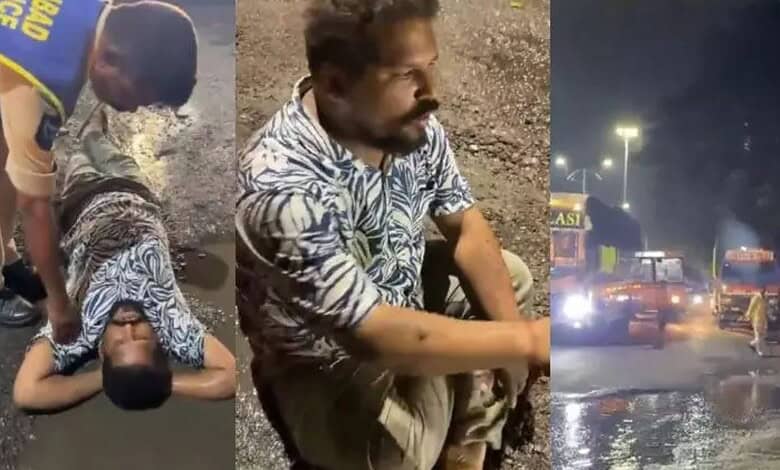Man sits in a pothole in Hyderabad
