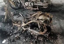 Burnt motorcycle remains after fire in Hyderabad apartment, six bikes gutted.