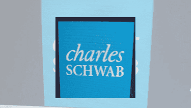 Charles Schwab logo displayed on a digital screen at a corporate event.