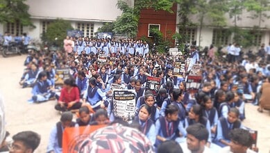 Polytechnic students in Hyderabad protest against Shakti scheme merger, holding banners and sitting in a团.