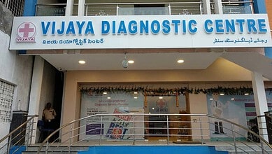 Vijaya Diagnostic Centre signboard with name in English, Telugu, and Arabic scripts.