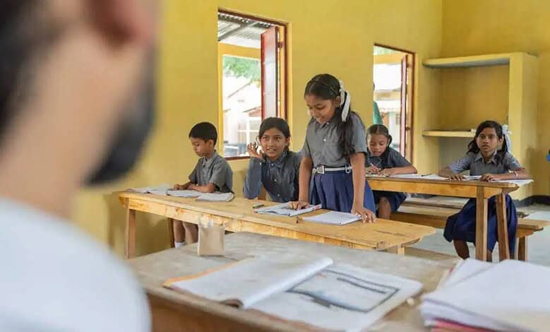 Young students in a classroom with yellow walls and open windows, engaged in learning activities.