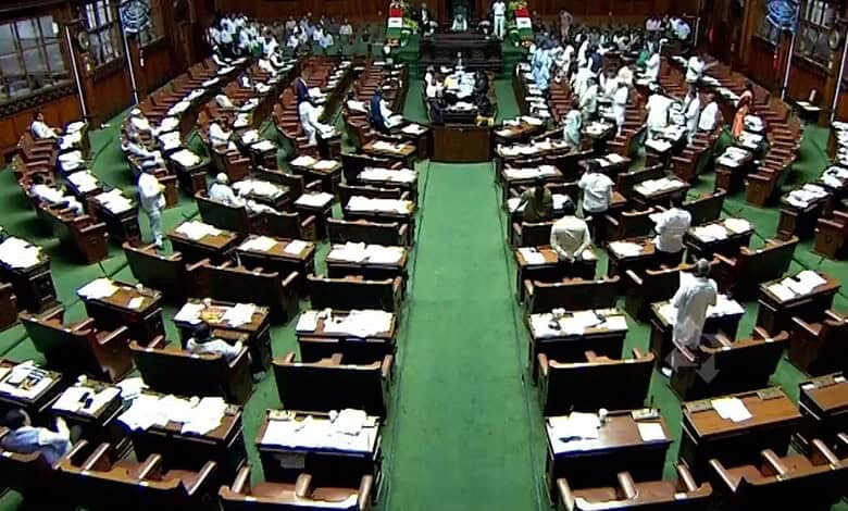 Karnataka Assembly session with members seated in a semi-circular arrangement.