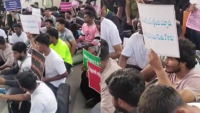 Unemployed youth protesting with placards during a rally over police recruitment issues.