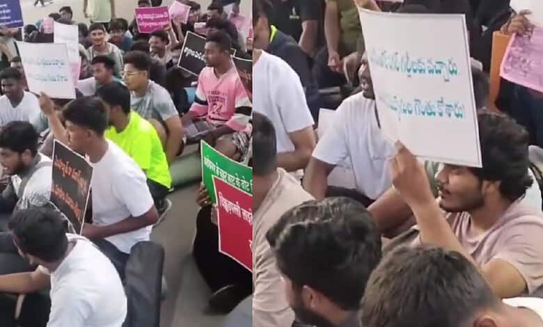 Unemployed youth protesting with placards during a rally over police recruitment issues.