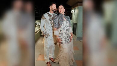 Gauahar Khan and Zaid Darbar posing together at a public event.