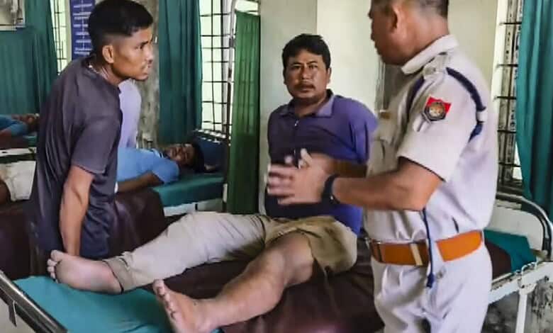 Hospital scene with injured man and police officer discussing his condition.