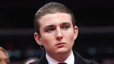 Portrait of a young man with slicked-back hair and serious expression.