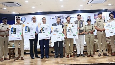 Hyderabad police officials and dignitaries showcase cybercrime prevention tools and certificates.