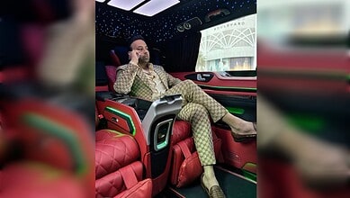 Satish Sanpal seated inside a luxury vehicle.