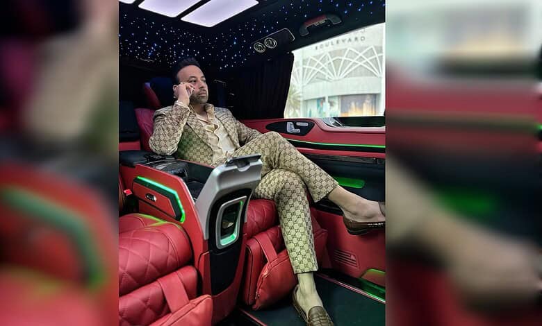 Satish Sanpal seated inside a luxury vehicle.