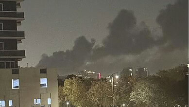 Dark smoke rising from Jebel Ali area after multiple explosions at night.