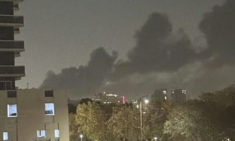 Dark smoke rising from Jebel Ali area after multiple explosions at night.