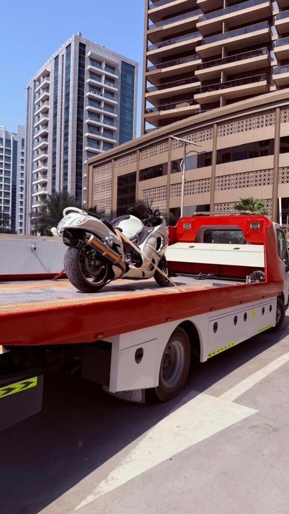 Impounded motorcycle loaded onto a Dubai Police recovery truck.