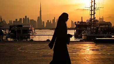 Dubai skyline overlooking the waterfront at sunset.