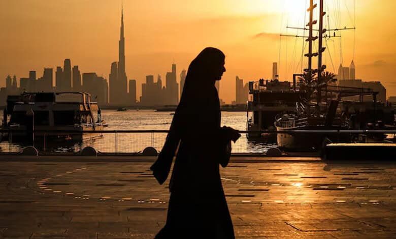 Dubai skyline overlooking the waterfront at sunset.