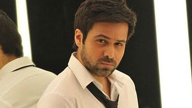 Emraan Hashmi in a white shirt with a serious expression, looking at the camera.