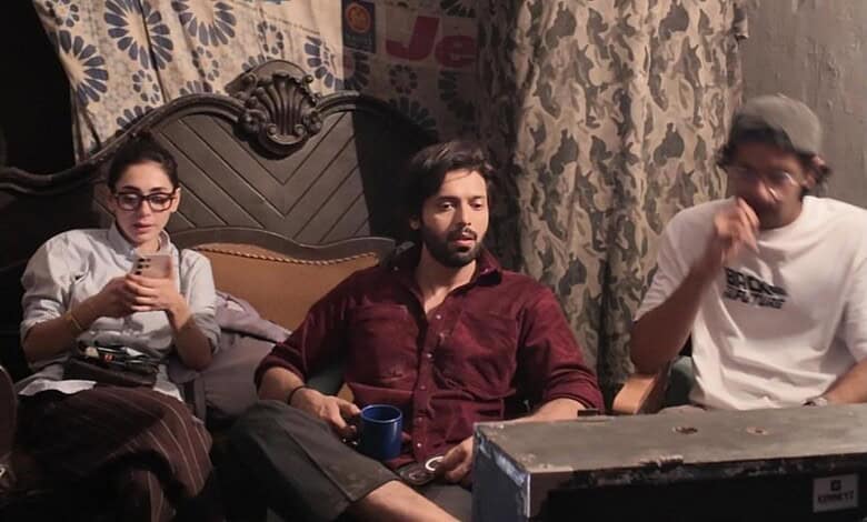 Pakistani actor Fahad Mustafa with two women in a casual indoor setting.
