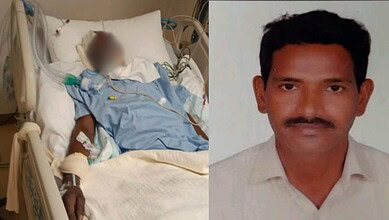 Critical ill worker in hospital bed with medical equipment, next to a portrait of a man.