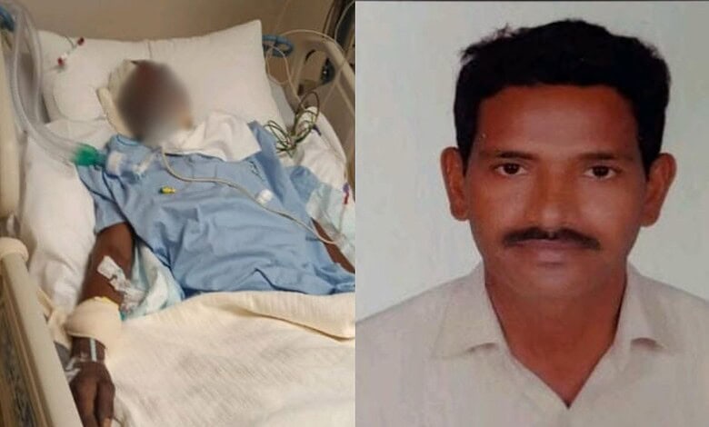 Critical ill worker in hospital bed with medical equipment, next to a portrait of a man.