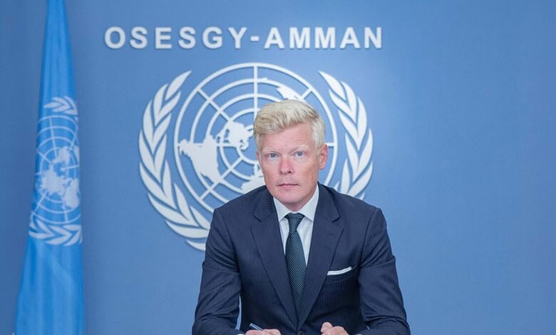 UN envoy speaking at a press conference with UN emblem in the background in Yemen.