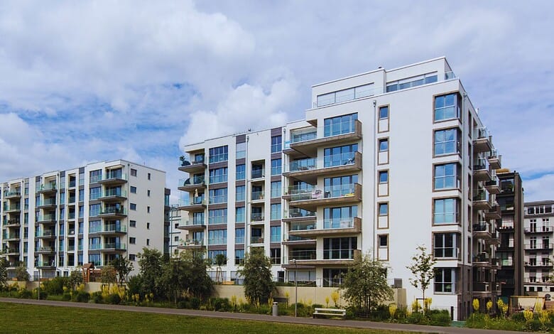 Modern residential apartment buildings in Hyderabad with balconies and greenery.