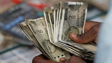 Close-up of Indian Rupees being held, symbolising financial dealings and currency exchange.
