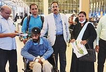 Indian worker with colleagues at airport after returning from Saudi Arabia.