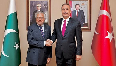 Ishaq Dar shakes hands with Turkish Foreign Minister Hakan Fidan in Istanbul.