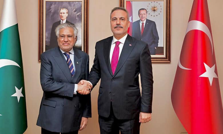Ishaq Dar shakes hands with Turkish Foreign Minister Hakan Fidan in Istanbul.