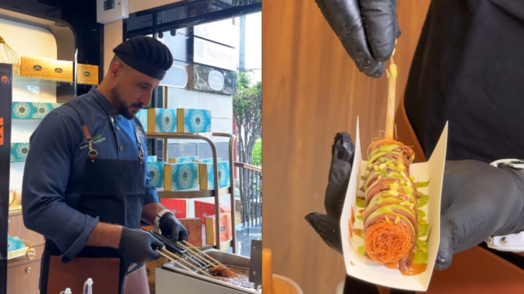 Chef preparing Kunafa dessert with colourful toppings in a bakery shop.