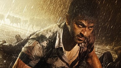 Prithviraj in a dark, rainy scene from Khalifa trailer, showing a serious expression and wet hair.