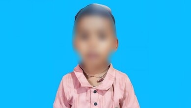 Child with blurred face holding a plastic ball, related to snack safety concerns.