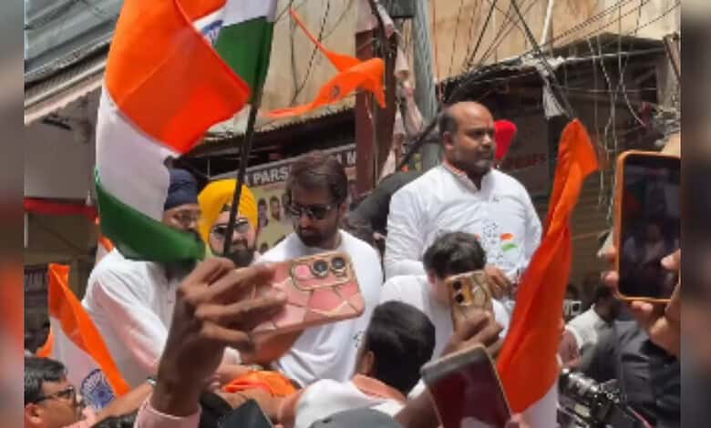 Politicians and supporters celebrating Independence Day with Indian flags at Begum Bazar.