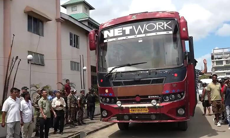 Public transport bus on NH-2 in Manipur after 3 years, with people gathered around.