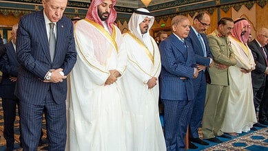 World leaders praying together in Makkah during a religious gathering.