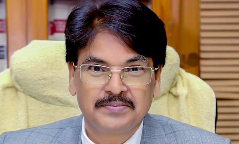 Portrait of BCI Chairman with glasses and mustache in office setting.