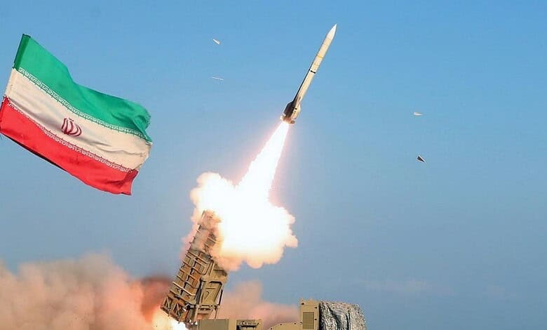 Iranian missile being launched with the national flag in the background during a military test.