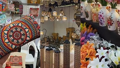 Vibrant handcrafted decorative items including bags, lamps, and vases displayed at a market stall.