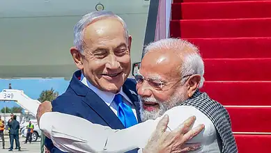 Indian Prime Minister Narendra Modi and Israeli Prime Minister Benjamin Netanyahu embrace at airport.
