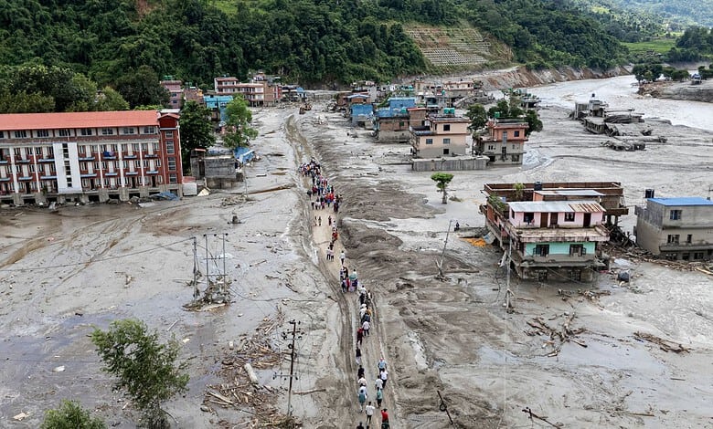 People move to a safer place after flash floods, in Devighat Bidur Municipality area, Nuwakot, Nepal, Thursday, Aug. 27, 2026. The death toll from the devastating flash floods surged to 359 on Thursday. (PTI Photo/Abhishek Maharjan)