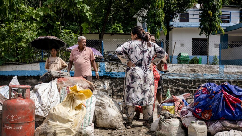 Local residents collect their belongings in the aftermath of flash floods, at the Devighat in Bidur, Nuwakot, Nepal, Thursday, Aug. 27, 2026. The death toll from the devastating flash floods surged to 359 on Thursday. (PTI Photo/Abhishek Maharjan)