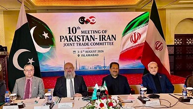 Pakistan and Iranian officials pose at the 10th Pakistan-Iran Joint Trade Committee meeting in Islamabad, with national flags and an event backdrop displaying the conference title and dates.
