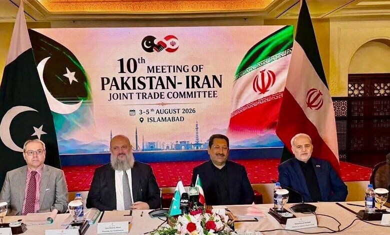 Pakistan and Iranian officials pose at the 10th Pakistan-Iran Joint Trade Committee meeting in Islamabad, with national flags and an event backdrop displaying the conference title and dates.