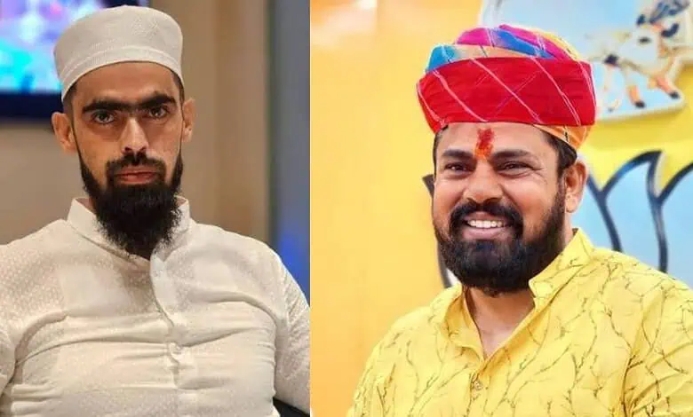 Two men in traditional attire, one with a white cap and the other with a red turban, smiling.