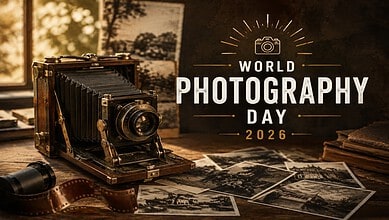 Vintage camera on a wooden table with photographs, celebrating World Photography Day 2026.